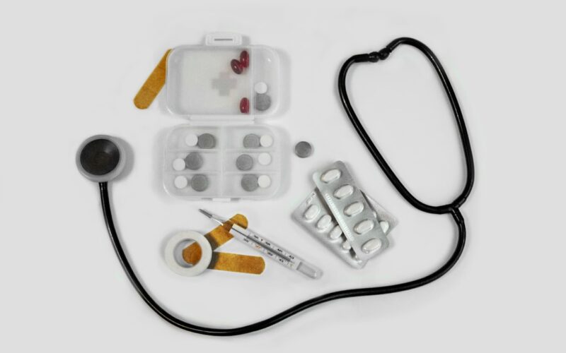 white and black earbuds on white textile